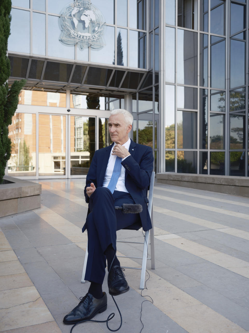 Interpol Secretary General Jurgen Stock talks to journalists during an interview outside the Interpol headquarters in Lyon, central France, Tuesday, Sept. 5, 2023. Jürgen Stock, who was appointed to the post in 2014 is beginning his last year in office. Interpol, which was founded in 1923, is celebrating its 100th anniversary this month. (AP Photo/Laurent Cipriani)