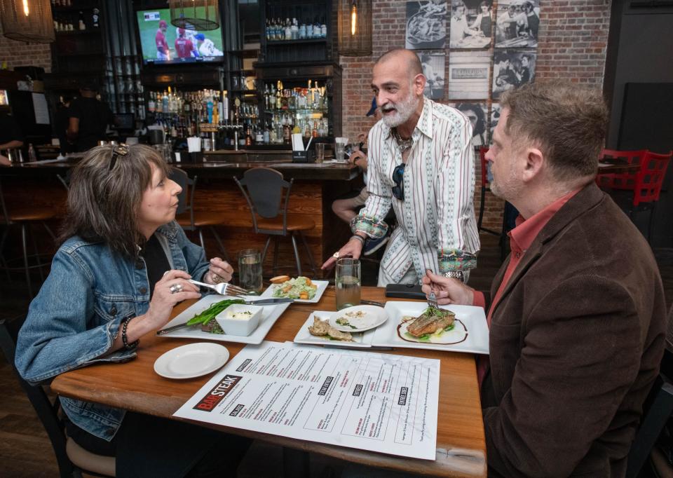 Owner Johnny Mascia, center, chats with local chefs Sandy Verlleux, left, and Matthew Brown at the new BarSteak restaurant on Palafox Place during a soft opening in downtown Pensacola on Tuesday, Oct. 3, 2023.