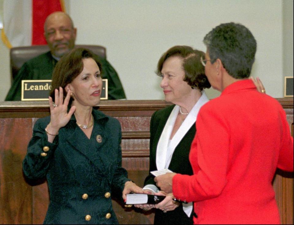 Barbara Joan Pariente takes her oath of office as a member of the state Supreme Court in front of former Justice Rosemary Barkett, Florida’s first female Supreme Court Justice, right, as Pariente’s mother, Mildred, holds the bible on Feb. 20, 1998, in Tallahassee, Fla. Justice Leander Shaw Jr. watches. Pariente was the second woman to be appointed to the post.