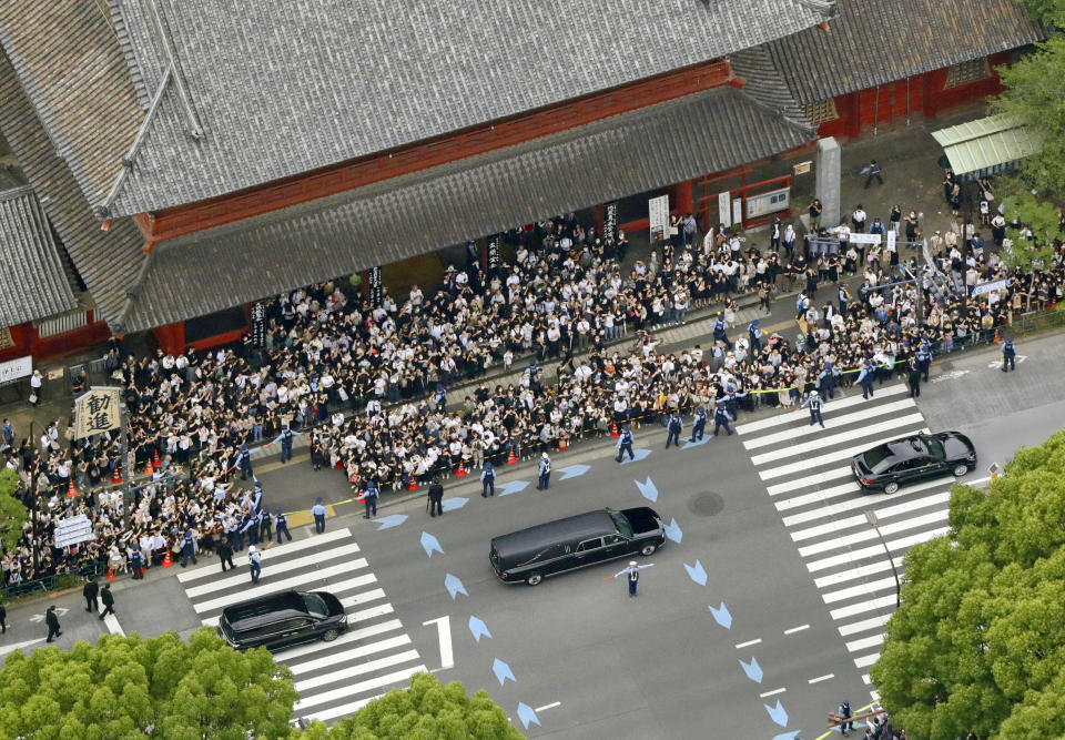 The hearse carrying former Prime Minister Shinzo Abe, leaves Zojoji temple after his funeral in Tokyo on Tuesday, July 12, 2022. Abe was assassinated Friday while campaigning in Nara, western Japan.(Kyodo News via AP)