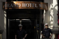 Police officers stand in front of the 'Grand Hotel Vienna' where where closed-door nuclear talks take place in Vienna, Austria, Saturday, June 12, 2021. (AP Photo/Florian Schroetter)