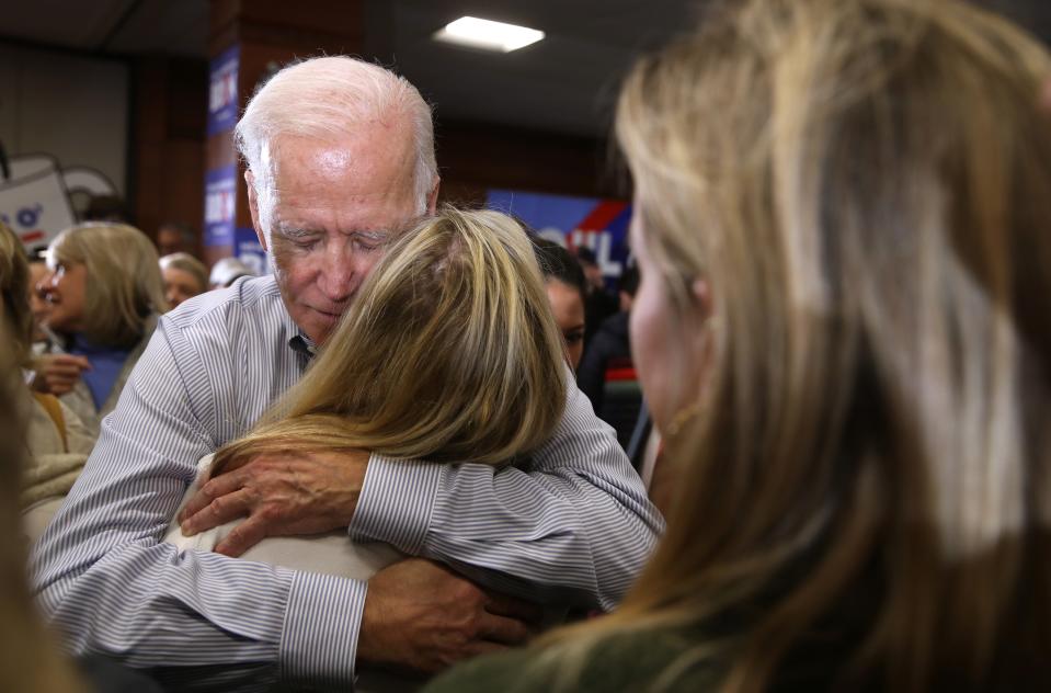 Democratic presidential candidate former Vice President Joe Biden hugs a voter during a campaign event at Ashworth by the Sea on Feb. 9, 2020 in Hampton, New Hampshire.