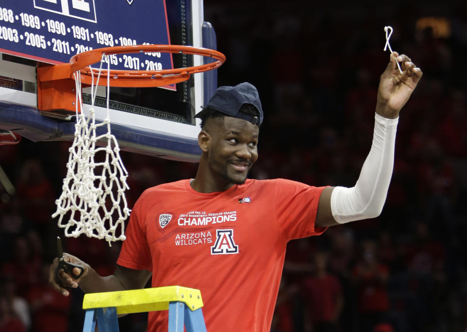 Arizona forward Deandre Ayton (13) cuts down the net after winning the Pac-12 title after an NCAA college basketball game against California, Saturday, March 3, 2018, in Tucson, Ariz. Arizona defeated California 66-54. (AP Photo/Rick Scuteri)