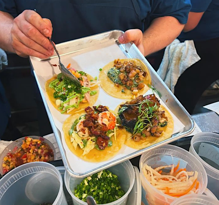 Artisan tacos being plated at Craft Taco Co.