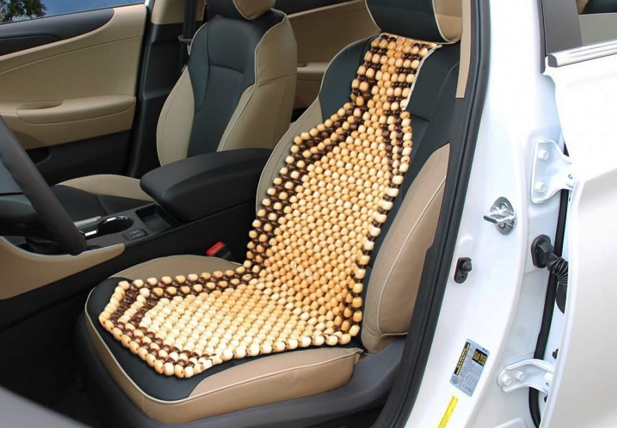 <p>Beloved of taxi seemingly drivers everywhere, the beaded seat cover has its origins in the <strong>hotter</strong> climes of Asia in the 1960s. The idea is it allows cooling air between seat and driver while still offering good support. Some have even claimed the beaded seat cover has <strong>back-healing</strong> qualities, though this is wholly unproven.</p><p>Held in place with a tie around the base of the headrest, the beaded seat cover has turned out to be one of the most <strong>enduring</strong> motoring fads. You can still buy them, usually finished in the same cream and brown colour scheme that epitomises this trend.</p>