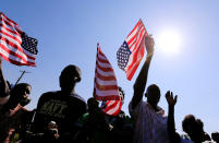 <p>Residents wave the U.S. national flag as they chant slogans on the road ahead of the visit by the former U.S. President Barack Obama to his ancestral Nyangoma Kogelo village in Siaya county, western Kenya July 16, 2018. (Photo: Thomas Mukoya/Reuters) </p>