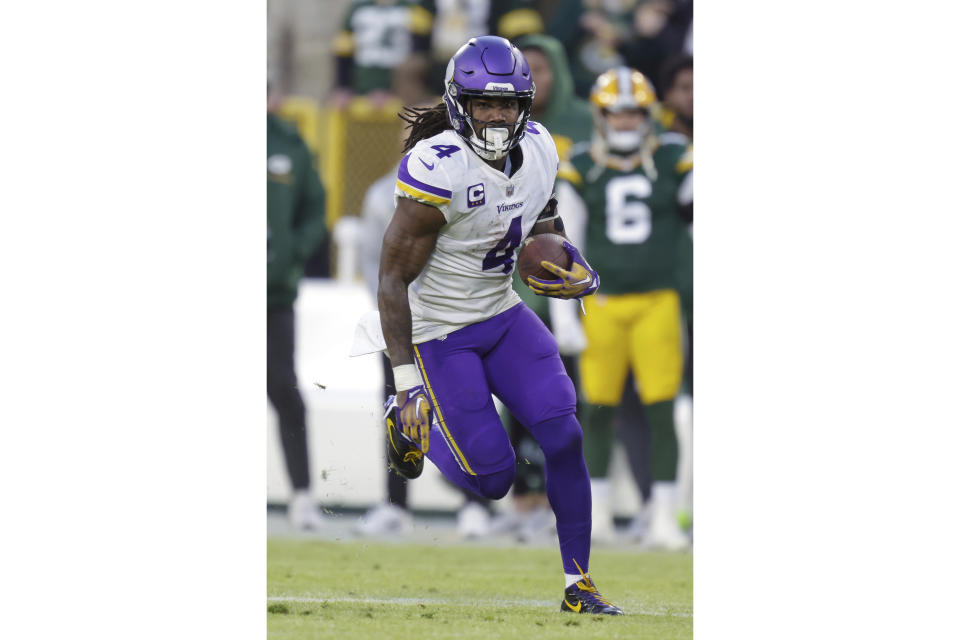 FILE - Minnesota Vikings running back Dalvin Cook (4) rushes during an NFL football game against the Green Bay Packers Sunday, Jan. 1, 2023, in Green Bay, Wis. DeAndre Hopkins and Dalvin Cook lead a list of accomplished players who are still available a week before several NFL teams open training camp. (AP Photo/Matt Ludtke, File)