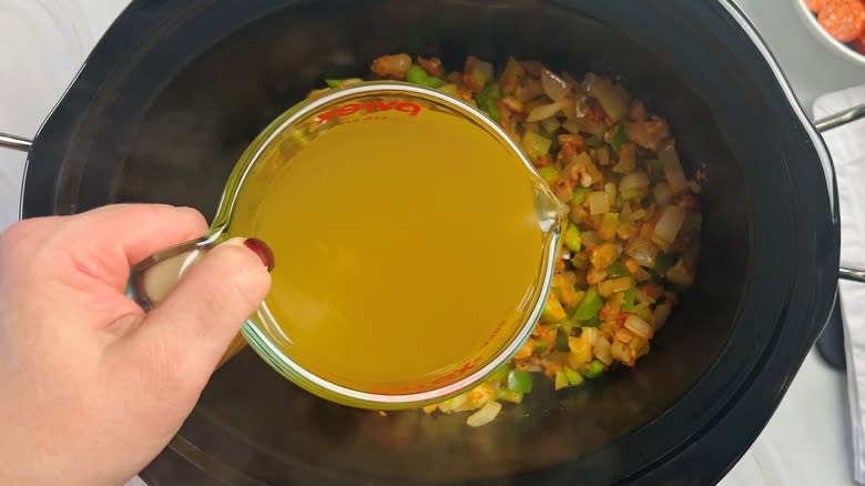 pouring stock into slow cooker