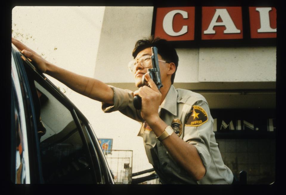 A security guard holds a gun.