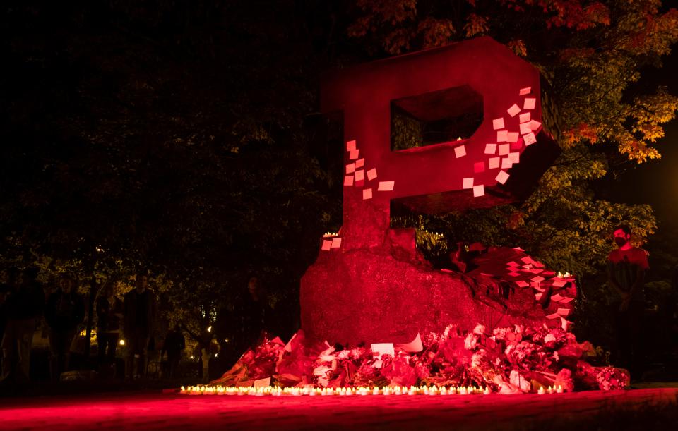 Students leave notes and battery powered lights on the ‘Unfinished Block P’ during a vigil for Varun Manish Chheda, Wednesday, Oct. 5, 2022, at Purdue University in West Lafayette, Ind. Varun Manish Chheda, a student at Purdue, was killed inside McCutcheon Hall early Wednesday.