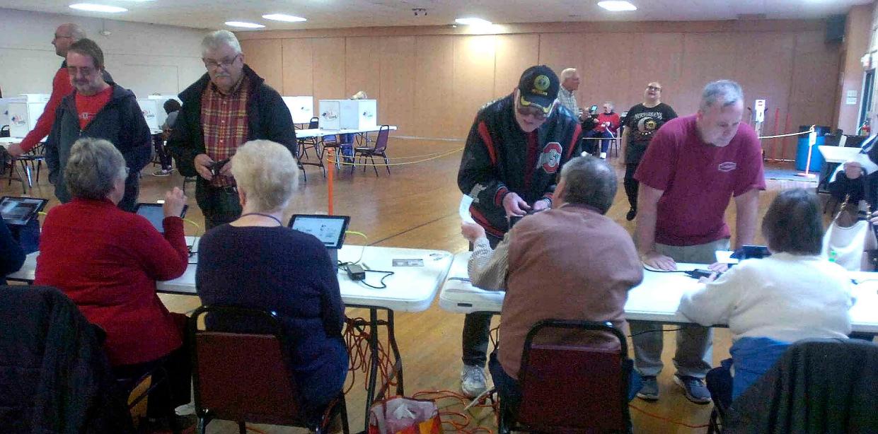 Voters sign in to vote in one of the eight precincts at Mozelle Hall on Tuesday morning.