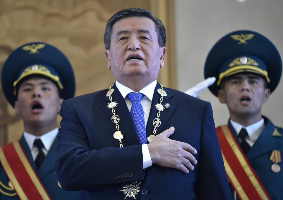 FILE - In this file photo taken on Friday, Nov. 24, 2017, President-elect Sooronbai Jeenbekov sings the national anthem during the presidential inauguration ceremony in Bishkek, Kyrgyzstan. Kyrgyzstan President Sooronbai Jeenbekov announced his resignation on Thursday, Oct. 15, 2020 in a bid to end the turmoil that has engulfed the Central Asian nation after a disputed parliamentary election. In a statement released by his office, Jeenbekov, who has faced calls to step down from protesters and political opponents, said that holding on to power wasn't "worth the integrity of our country and agreement in society." (Vyacheslav Oseledko/Pool Photo via AP, File)