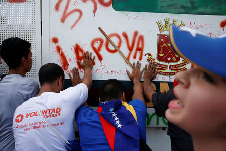 Opposition supporters protest in front of an anti-riot barricade during a rally against Venezuela's President Nicolas Maduro's government in Caracas, Venezuela April 1, 2017. REUTERS/Carlos Garcia Rawlins