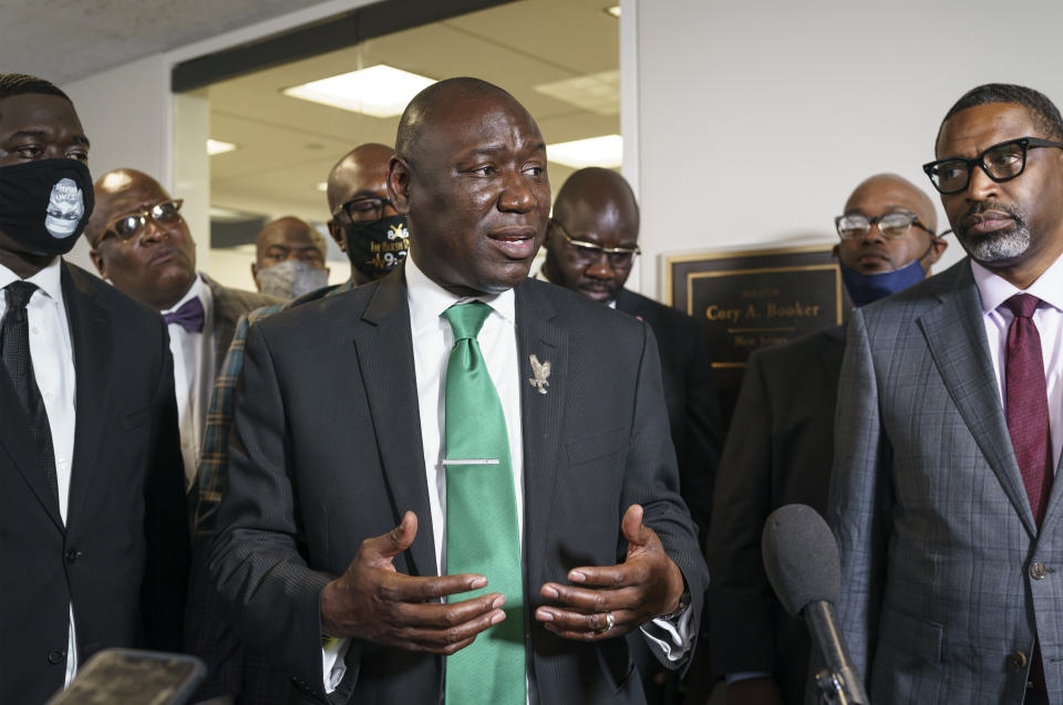 FILE - Ben Crump, center, the civil rights attorney representing the family of George Floyd, joined at right by NAACP President Derrick Johnson, speaks to reporters after they met with U.S. Sen. Cory Booker, D-N.J., about police reform legislation, at the Capitol in Washington, May 25, 2021, the first anniversary of Floyd's death at the hands of a white Minneapolis police officer. (AP Photo/J. Scott Applewhite, File)