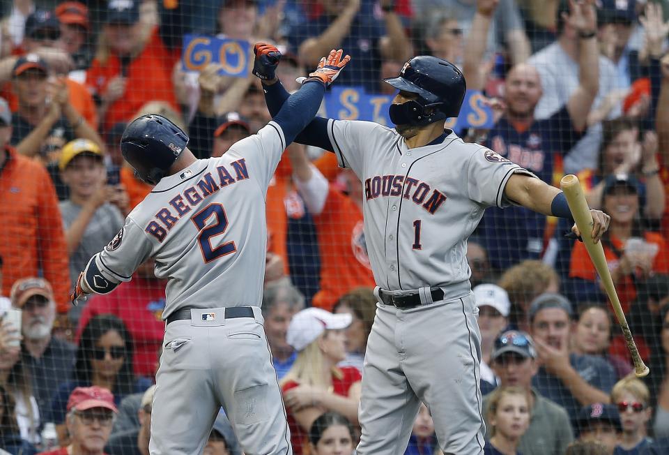 Houston Astros’ Alex Bregman (2) celebrates his solo home run with Carlos Correa (1) during the third inning against the Boston Red Sox. (AP Photo)