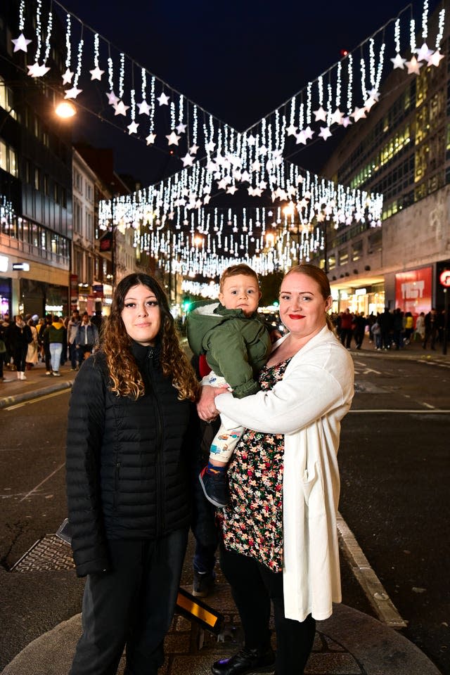 A Home-Start UK family attends the switch-on with the family support charity, which received 100 Christmas gift hampers from Oxford Street for them to distribute this winter