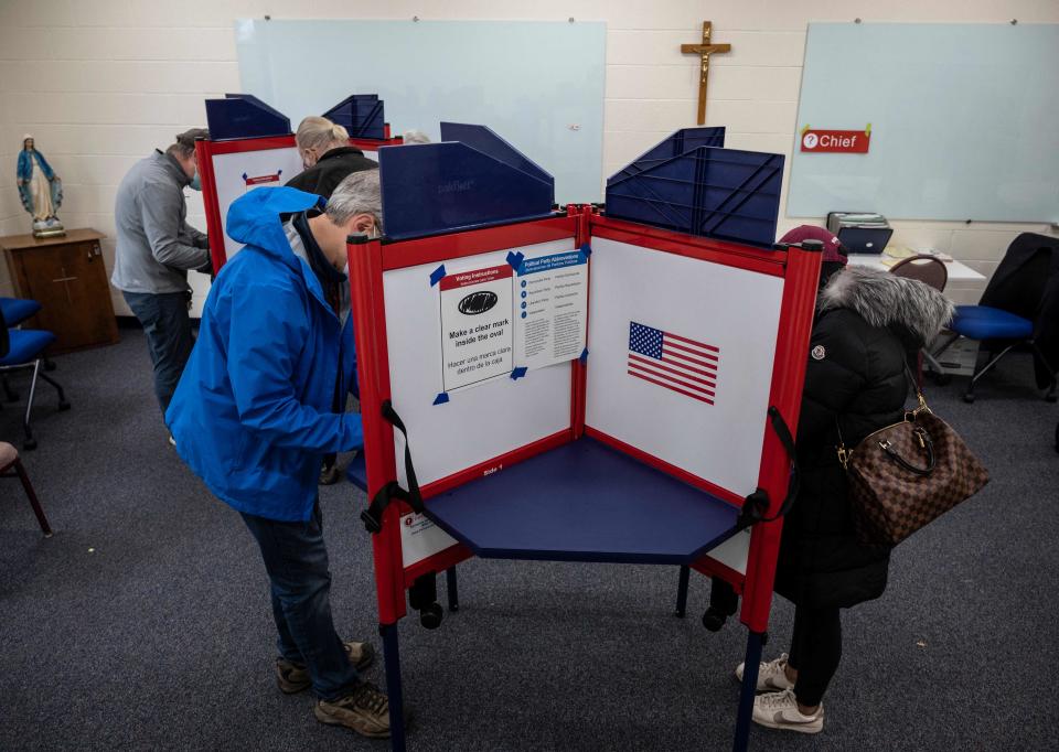 Voters fill out their ballots at a church being used as a polling station on election day in Arlington, Virginia, on Nov. 2, 2021.