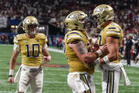 Georgia Tech tight end Brett Seither, right, celebrtes his touchdown with offensive lineman Weston Franklin (72) and quarterback Haynes King (10) during the first half of an NCAA college football game against Louisville, Friday, Sept. 1, 2023, in Atlanta. (AP Photo/Mike Stewart)