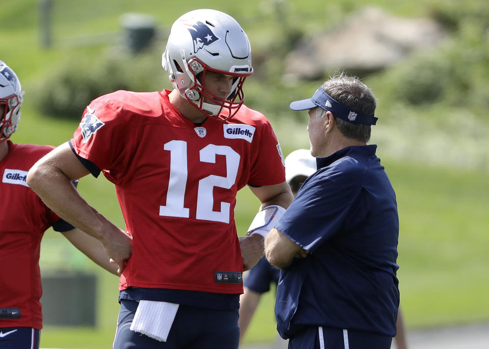 New England Patriots quarterback Tom Brady (12) speaks with head coach Bill Belichick, right, during NFL football practice, Wednesday, Sept. 11, 2019, in Foxborough, Mass. (AP Photo/Steven Senne)