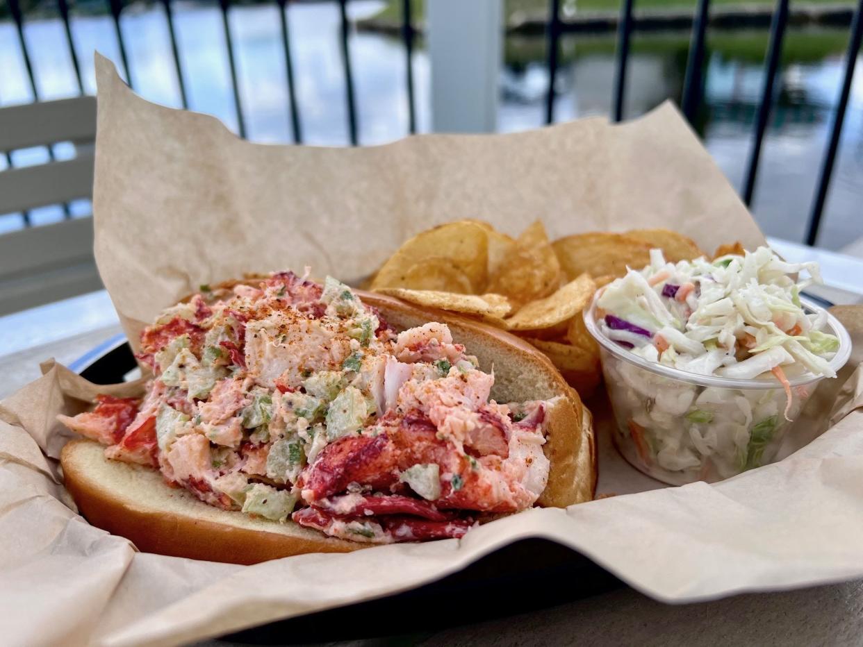 An overstuffed Maine lobster roll is served at the new Outclaws Seafood market café in North Palm Beach.