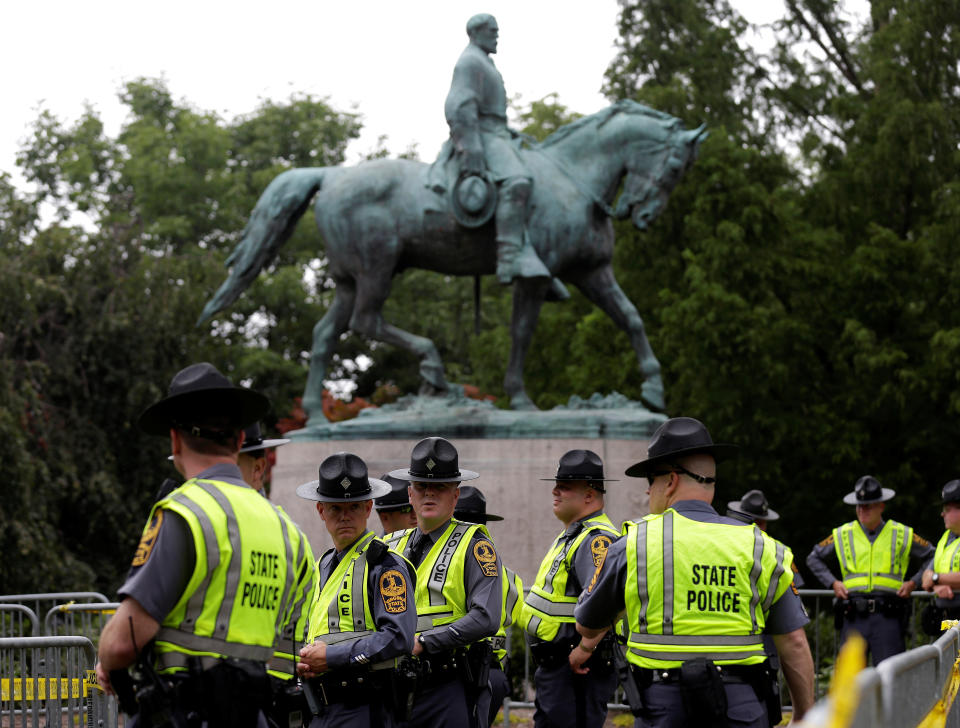 Virginia State Troopers stand under a statue of Robert E. Lee.&nbsp;White nationalists descended on Charlottesville to protest the statue's removal.