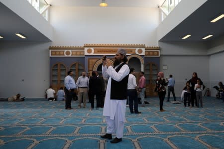 A Muslim man takes pictures inside the first official mosque in Athens