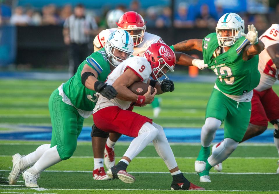 West Florida's Kenneth Martin and Michael take down West Alabama's quarterback Spencer Arceneaux at Penair Field at the University of West Florida Saturday, September 21, 2024.