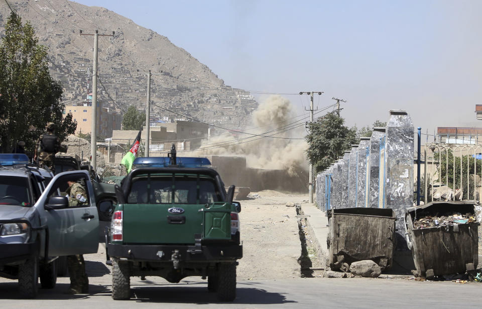 Smoke rises from a house where attackers are hiding after being bombed in Kabul, Afghanistan, Tuesday, Aug. 21, 2018. The Taliban fired rockets toward the presidential palace in Kabul Tuesday as President Ashraf Ghani was giving his holiday message for the Muslim celebrations of Eid al-Adha, said police official Jan Agha. (AP Photo/Rahmat Gul)