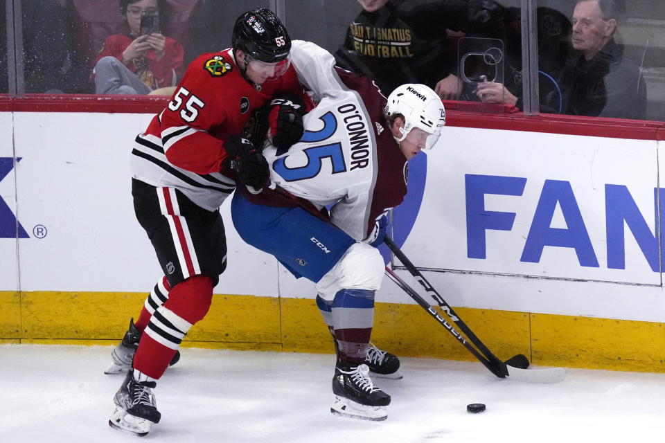 Colorado Avalanche right wing Logan O'Connor, right, looks to pass the puck against Chicago Blackhawks defenseman Kevin Korchinski (55) during the second period of an NHL hockey game in Chicago, Thursday, Feb. 29, 2024. (AP Photo/Nam Y. Huh)