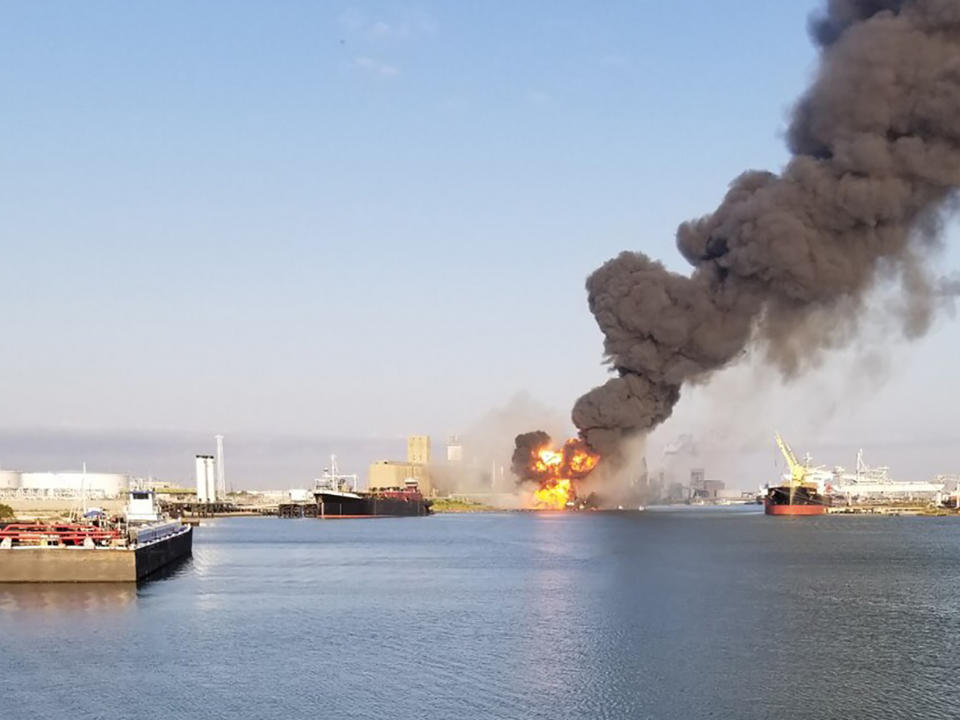 CORRECTS TO PROPANE PIPELINE INSTEAD OF A NATURAL GAS PIPELINE - In this photo released by the U.S. Coast Guard, Coast Guard crews respond to a dredge on fire in the Port of Corpus Christi Ship Channel, Aug. 21, 2020 in Corpus Christi, Texas. Authorities say several people have been hospitalized after an explosion at the Texas port when a dredging vessel hit a propane gas pipeline in the water. (U.S. Coast Guard via AP)