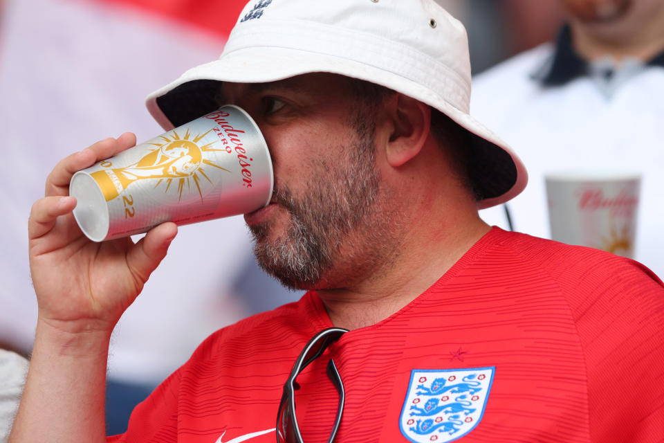 DOHA, QATAR - NOVEMBER 21: An England fan drinks a non-alcoholic beer prior to the FIFA World Cup Qatar 2022 Group B match between England and IR Iran at Khalifa International Stadium on November 21, 2022 in Doha, Qatar. (Photo by Marc Atkins/Getty Images)