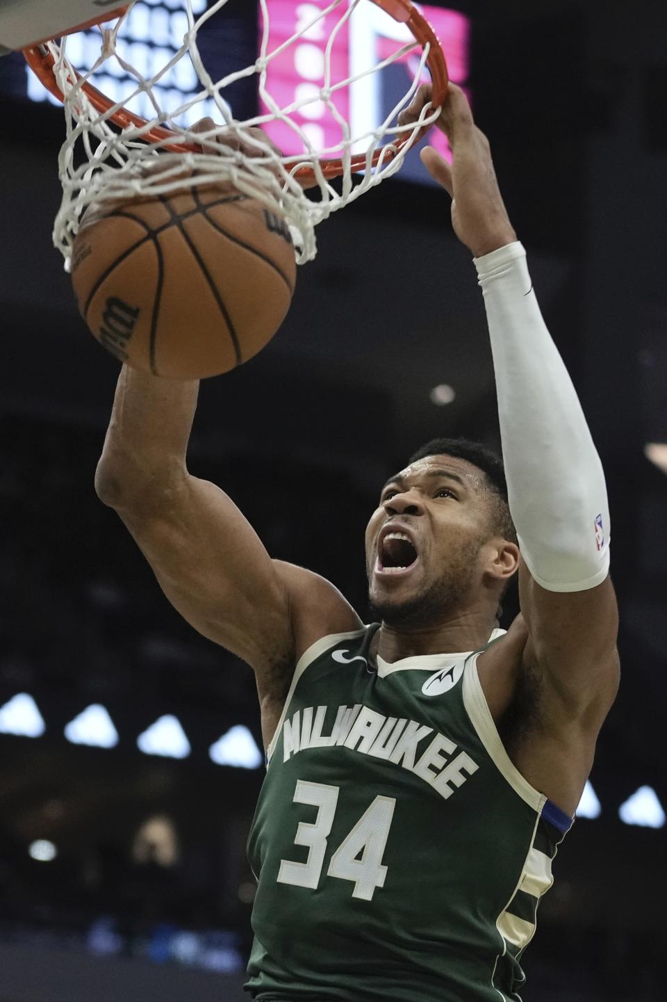 Milwaukee Bucks' Giannis Antetokounmpo dunks during the first half of an NBA basketball game Monday, Dec. 11, 2023, in Milwaukee. (AP Photo/Morry Gash)