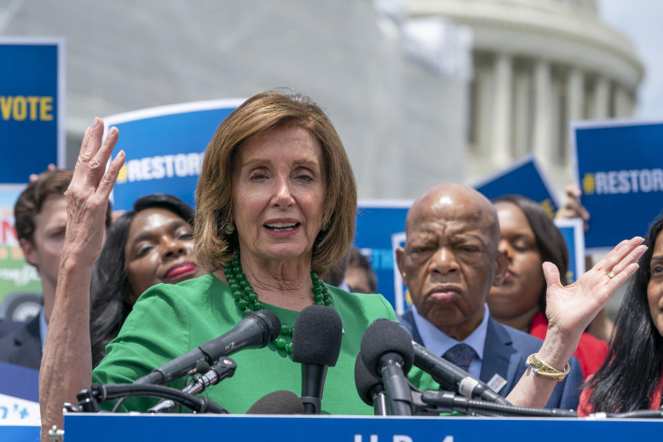 Speaker of the House Nancy Pelosi, D-Calif., flanked by Rep. Terri Sewell, D-Ala., left, and Rep. John Lewis, D-Ga., right, talks to reporters about the need for the Voting Rights Advancement Act of 2019, at the Capitol in Washington, Tuesday, June 25, 2019. (AP Photo/J. Scott Applewhite)