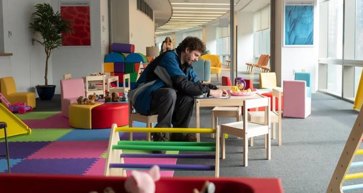 A man sits in a kids' indoor playground in Life & Beth.