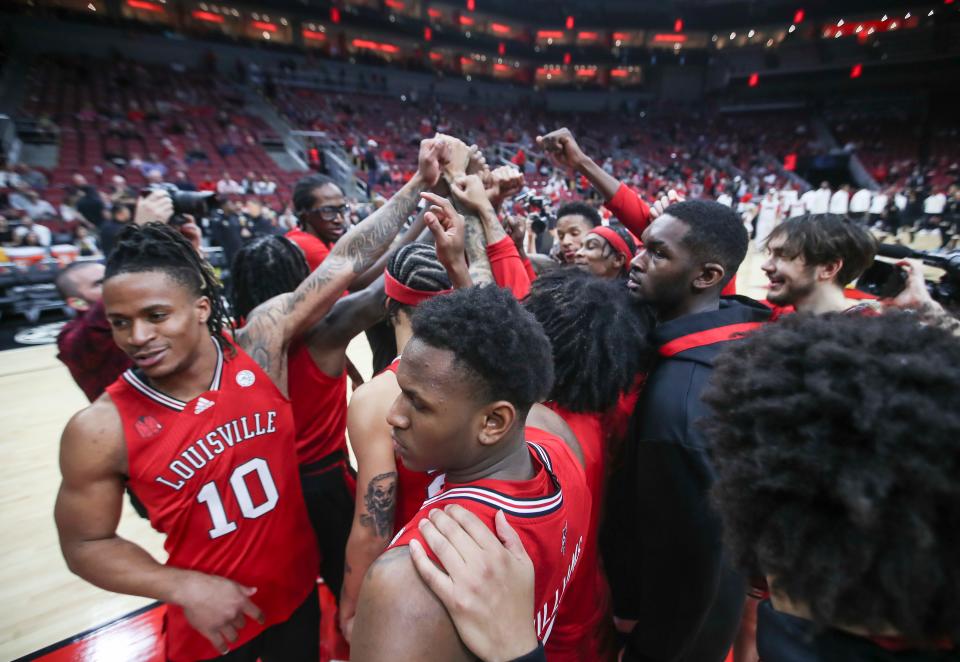 The Louisville basketball team huddle up before the opening game of the 2023-24 season.