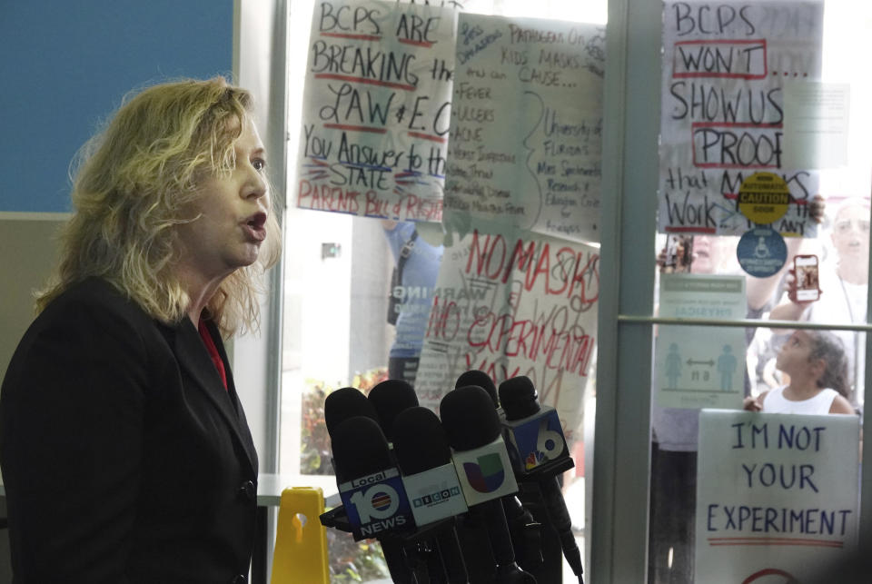 FILE - In this Aug. 24, 2021, file photo, anti-mask and anti-testing protesters shout during a news conference by Broward County Schools Interim Superintendent Vickie Cartwright, in Fort Lauderdale, Fla. The news conference followed a school board meeting about COVID-19 testing in schools. A growing number of school board members across the U.S. are resigning or questioning their willingness to serve as meetings have devolved into shouting contests over contentious issues including masks in schools. (Joe Cavaretta/South Florida Sun-Sentinel via AP, File)