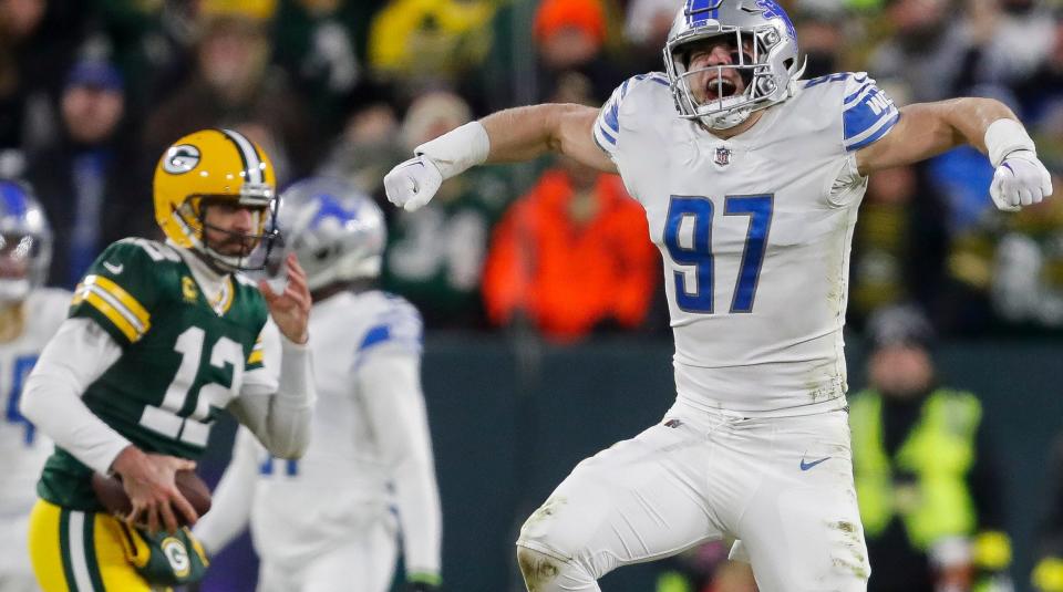 Detroit Lions defensive end Aidan Hutchinson (97) celebrates after sacking Green Bay Packers quarterback Aaron Rodgers.