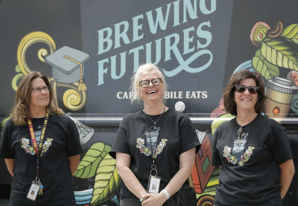 Oshkosh Area School District staff, from left, Patti Kimball, Kris Steinhilber and Mary Beth Conners attend the ribbon-cutting ceremony Tuesday, for OASD's Brewing Futures Mobile Cafe in the administration office's parking lot.