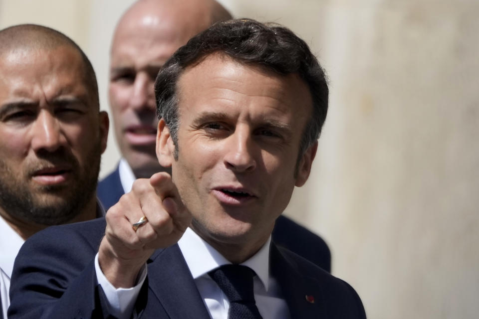 FILE -Centrist presidential candidate and French President Emmanuel Macron gestures as he arrives for a campaign stop Thursday, April 21, 2022 in Saint-Denis, outside Paris. French voters head to polls on Sunday in a runoff vote between centrist incumbent Emmanuel Macron and nationalist rival Marine Le Pen. On Friday, April 22, 2022, The Associated Press reported on stories circulating online incorrectly claiming the BBC tweeted that Macron said France needs to be prepared to take up to 60 million refugees from Africa and the Middle East over the next 20 years because sanctions against Russia will cause economic collapse in Africa. (AP Photo/Francois Mori, File)