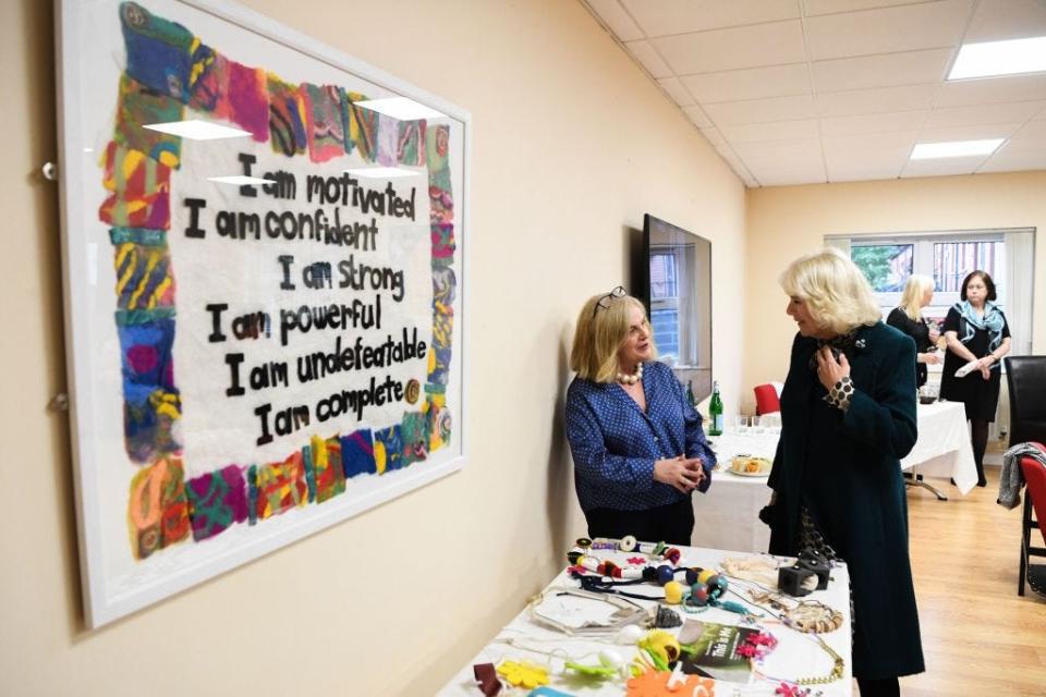 Camilla, then Duchess of Cornwall, speaks to staff at a women's charity.