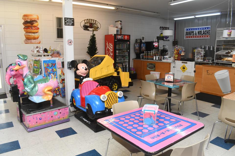 There are coin-operated rides, like the kind that used to be in front of stores, around the inside of the Poppa J's Donuts/Sweet and Eats Fun Zone in Bunkie. In addition, the table tops are painted with games.