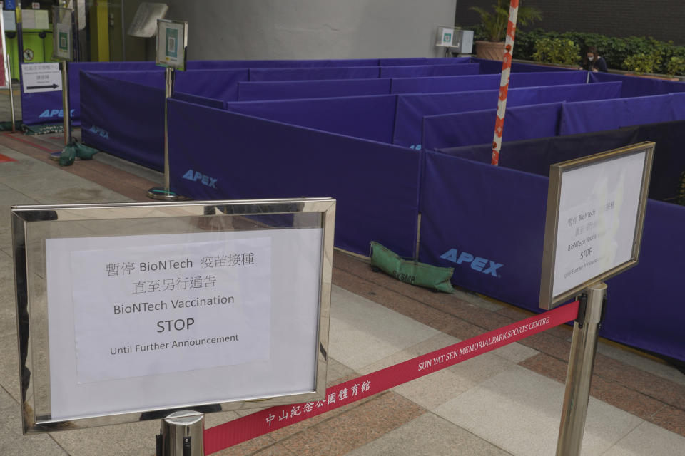 A notice of vaccine suspension is placed outside a vaccination center for BioNTech in Hong Kong Wednesday, March 24, 2021.. Hong Kong suspended vaccinations using Pfizer shots - known as BioNTech shots in the city - on Wednesday after they were informed by its distributor Fosun that one batch had defective bottle lids. (AP Photo/Vincent Yu)