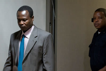 Dominic Ongwen (L), a senior commander in the Lord's Resistance Army, whose fugitive leader Kony is one of the world's most-wanted war crimes suspects, enters the court room of the International Court in The Hague, Netherlands, December 6, 2016. REUTERS/Peter Dejong