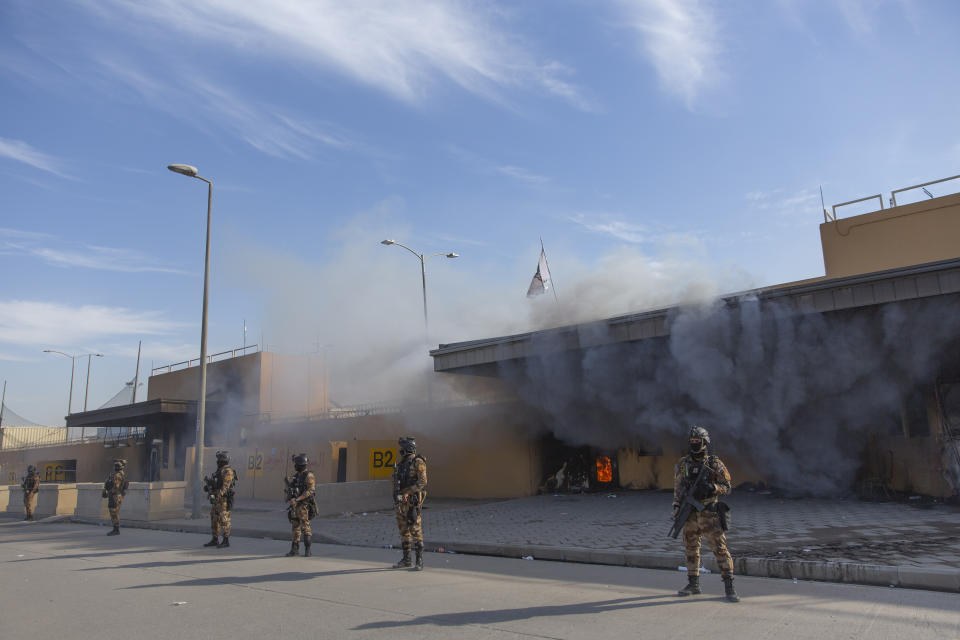 Iraqi army soldiers are deployed in front of the U.S. embassy, in Baghdad, Iraq, Wednesday, Jan. 1, 2020. Iran-backed militiamen have withdrawn from the U.S. Embassy compound in Baghdad after two days of clashes with American security forces. (AP Photo/Nasser Nasser)