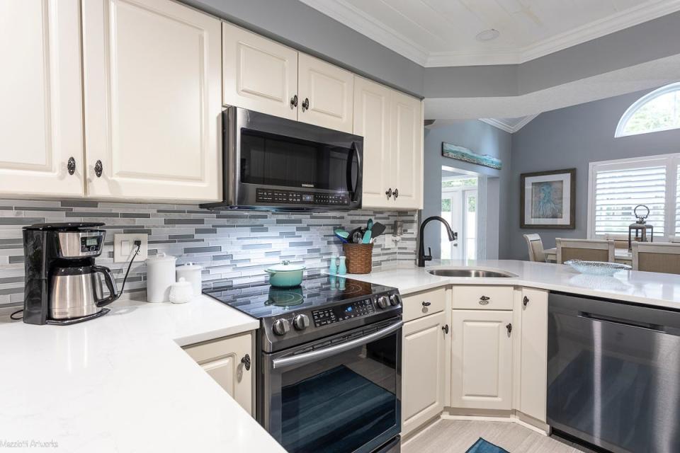 Newer Samsung appliances (2020) and quartz countertops add charm to the kitchen, which also boasts a large pantry with pull-out drawers and extra storage space.