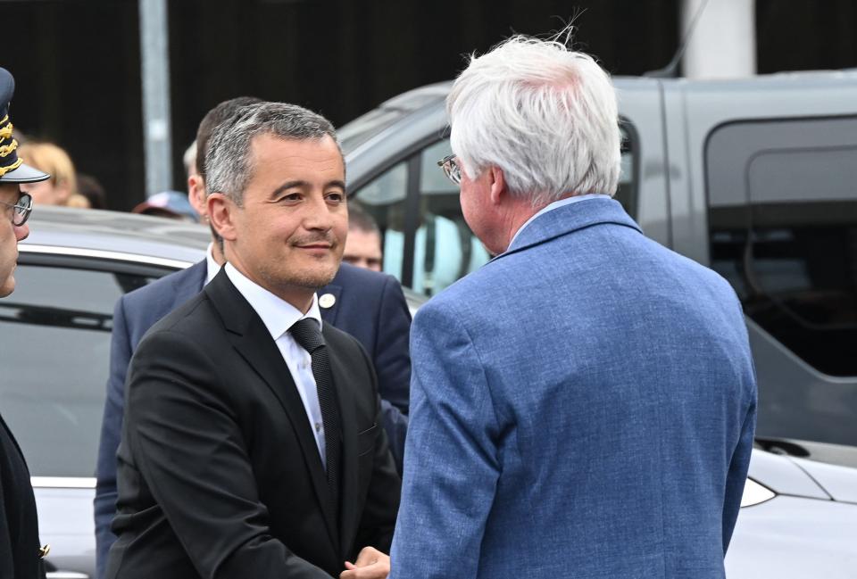 French Interior and Overseas Minister Gerald Darmanin (L) is greeted by Mons-en-Baroeul Mayor Rudy Eelegeest as he arrives in Mons-en-Baroeul, northern France, on June 29, 2023, after protests following the shooting of a teenage driver by a policeman in the Parisian suburb of Nanterre.