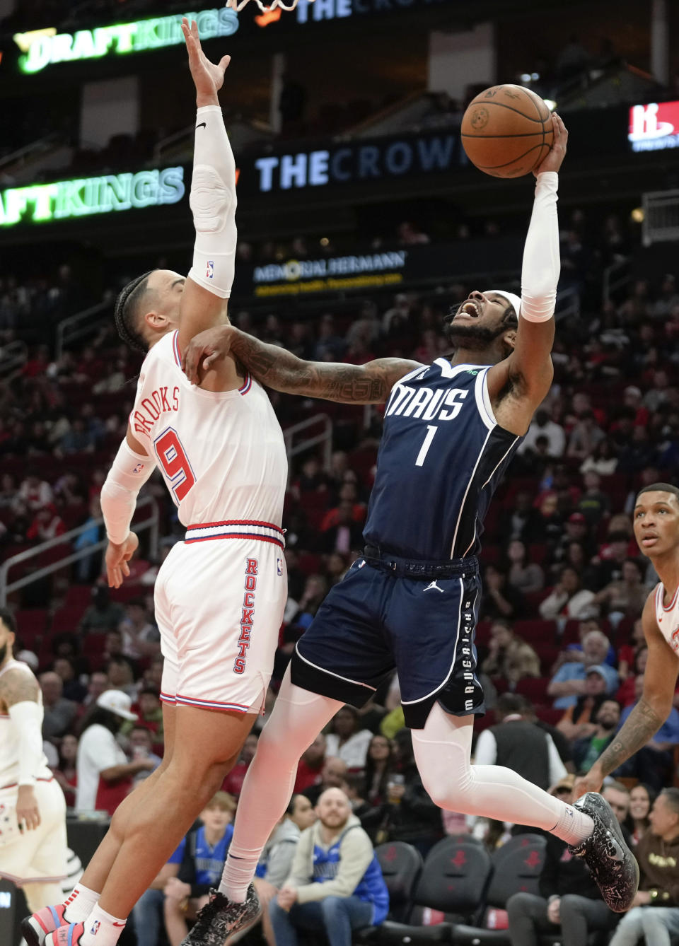 Dallas Mavericks guard Jaden Hardy (1) shoots as Houston Rockets forward Dillon Brooks (9) defends during the first half of an NBA basketball game Friday, Dec. 22, 2023, in Houston. (AP Photo/Eric Christian Smith)