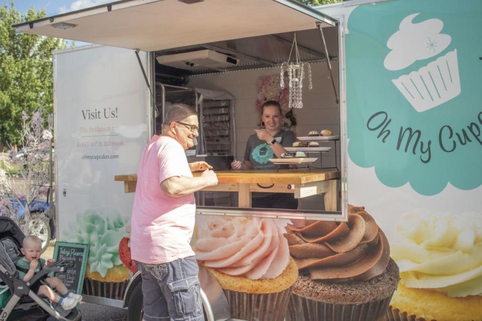 A customer approaches the new Oh My Cupcakes! mobile unit.