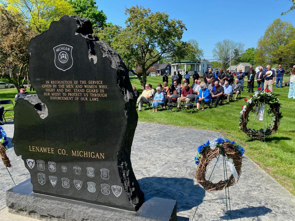 Members of Lenawee County’s law enforcement community and relatives of officers who have died in the line of duty in the county bow their heads as the Rev. Michael Newman of Holy Family Parish in Adrian gives the benediction Monday during the annual Peace Officers Memorial Day service at Oakwood Cemetery in Adrian.