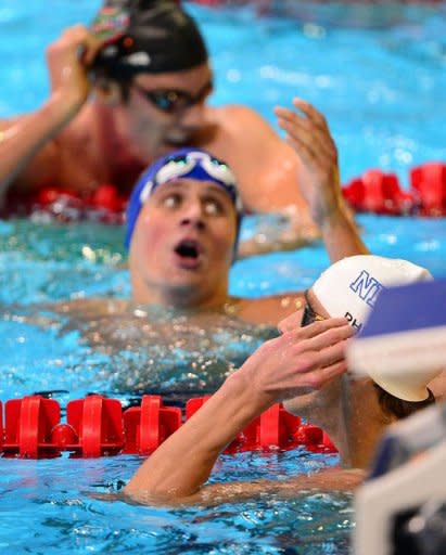 Ryan Lochte (C) reacts after losing to Michael Phelps (bottom) in the men's 200m individual medley final at the US Olympic Team Trials on June 30. Lochte was second in 1:54.93